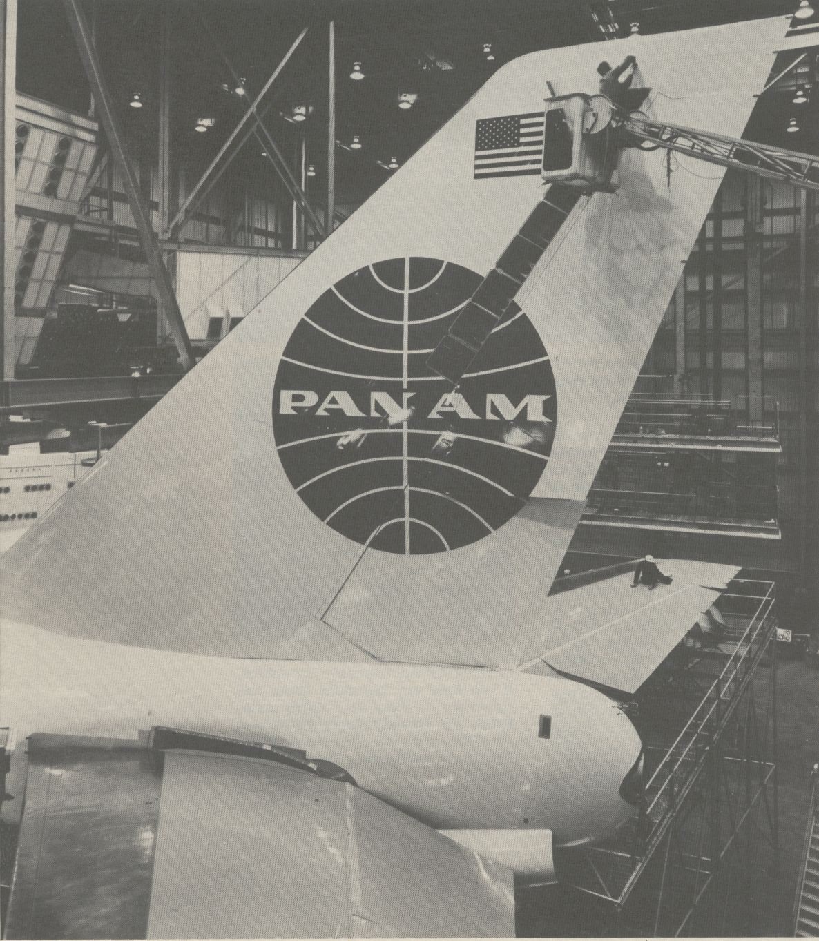 1970s  A Pan Am Boeing 747 in the hanger for maintenance.  The top of a 747 tail is as high as a six story building.